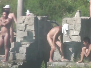 Asian men engage in gay sex outdoors by a lake